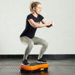 fitness-expert-does-a-squat-on-a-mirafit-vibration-plate-1024×683