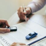 midsection-of-client-giving-money-to-car-insurance-royalty-free-image-1583602401
