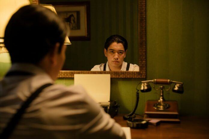 Asian man looking into a mirror