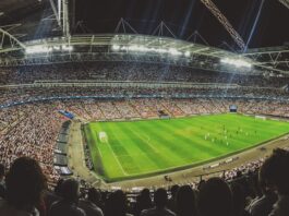 Crowd watching football game on the stadium
