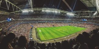 Crowd watching football game on the stadium