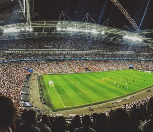 Crowd watching football game on the stadium