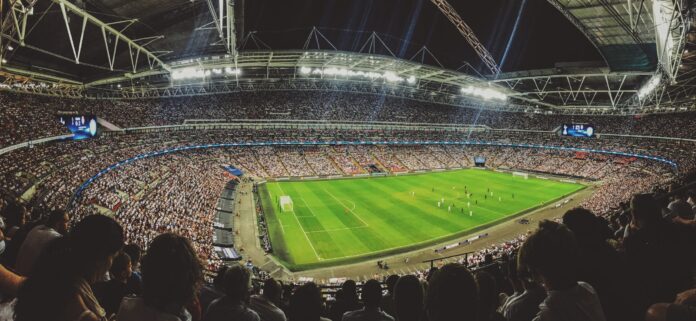 Crowd watching football game on the stadium