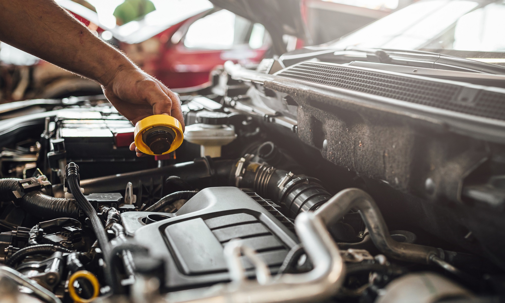 An auto mechanic working on a car engine, technical car inspection in service