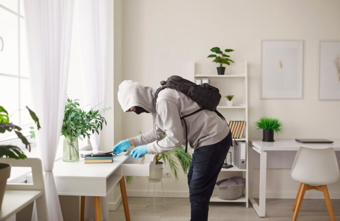 Masked Thief Burglarizing Home And Stealing From Table